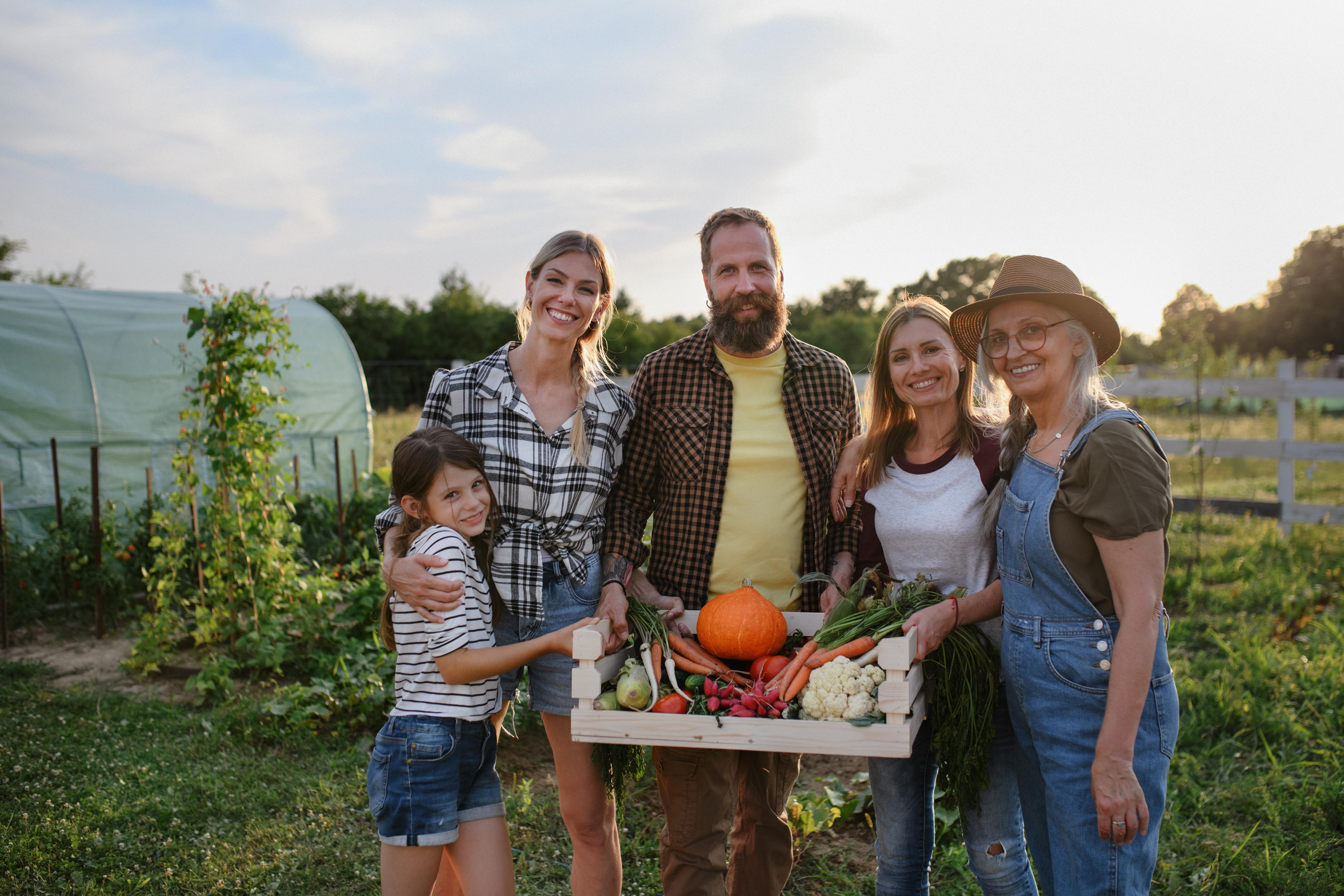 A family gardening outside their custom-built home – rural lifestyle and equestrian living at Excella Equine Estates near Edmonton.
