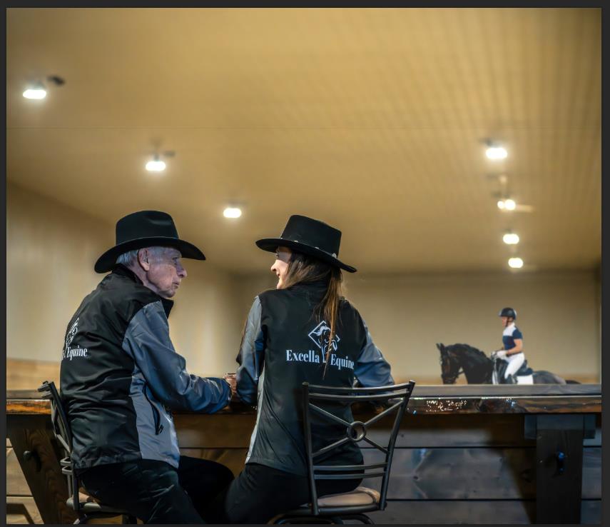 Lisa Levasseur and her father sit in the heated indoor arena viewing area – Excella Equine Park barn and training facility in Stony Plain.