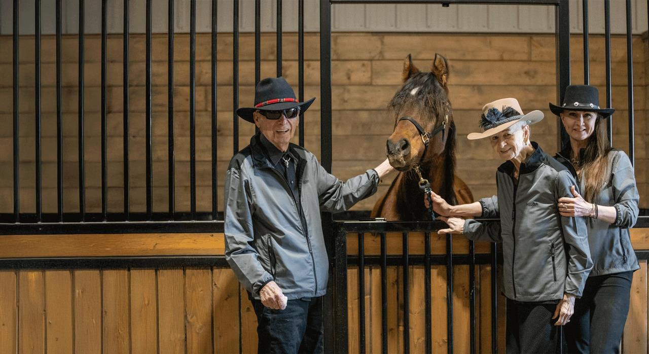 Lisa Levasseur and her family at the Excella Equine Park barn – Lisa founded Alberta's premier equestrian acreage community.